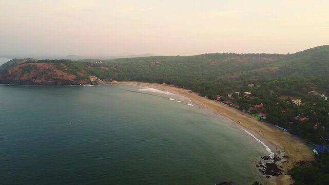 Beautiful sunset over the Arabian Sea, with the sun dipping below the horizon and warm golden light spreading across calm waters.