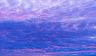Soft pastel cloud texture in purple and blue evening sky