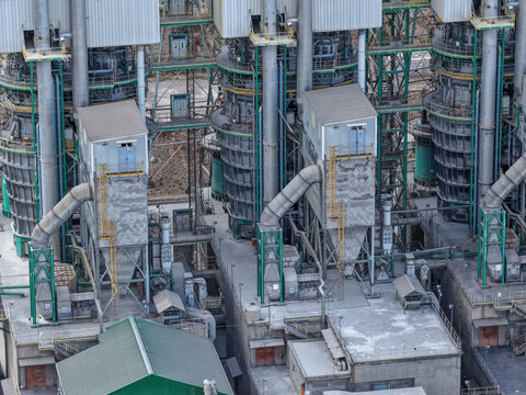 Aerial view of a cement production plant with 3 industrial electric kilns