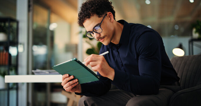 Creative man, web designer or night with tablet for online website, design or development in office. Businessman, writing or working late with technology for schedule, review or planning in workplace