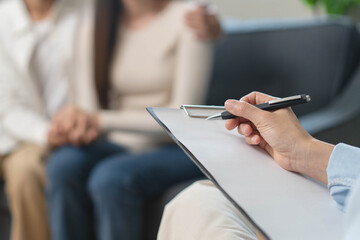 Spouses relationship consultant concept, Married couple listen to psychologist  during therapy talk session for married couple that mental health breakdown and relationship problems.