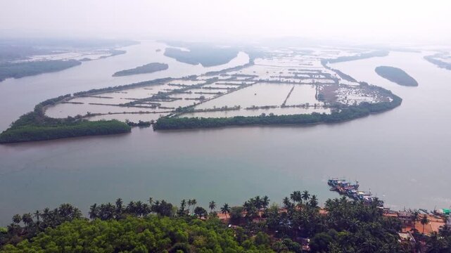 Aerial view of prawn farming ponds along the coastline, showcasing aquaculture and sustainable food production in Karnataka.