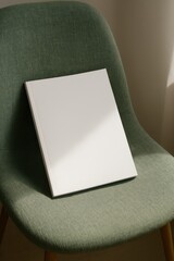 Obraz premium Blank book on green chair