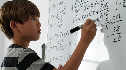 Young boy solving math equations - Powered by Adobe