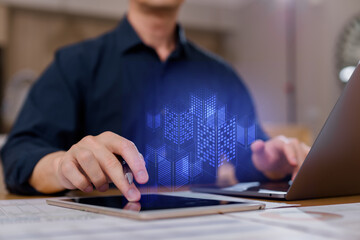 Businessman using digital tablet with 3D smart city hologram, concept of real estate technology, digital transformation, architecture urban planning innovation.