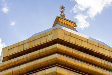 Elegant golden spire of a Thai Buddhist temple showcasing traditional craftsmanship, sacred symbolism, and cultural heritage in Thailand.