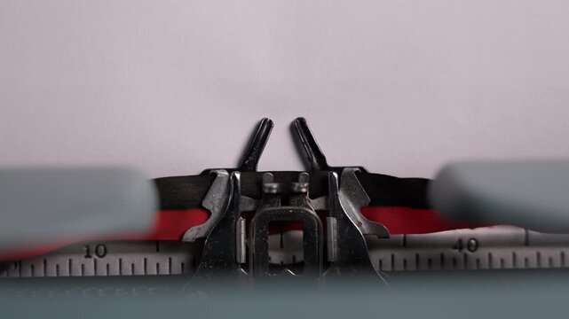 Close-up of a vintage typewriter mechanism printing the words to be continued on the paper. Moving metal parts and classic design create a nostalgic retro writing atmosphere.