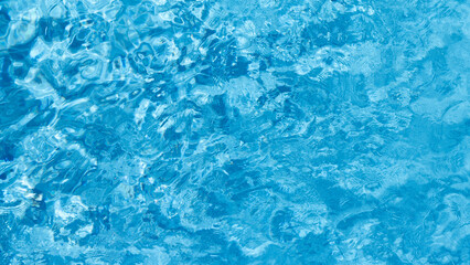 Fototapeta premium Top view blue water with ripple texture surface background, Blue water waves with shining pattern texture background, Abstract​​ surface​ blue​ water and ripple.
