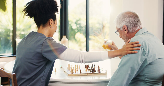Nurse, senior man and chess in home with cognitive wellness, juice and support with challenge in retirement. Elderly person, caregiver and play board game with brain function, drink and fun at house