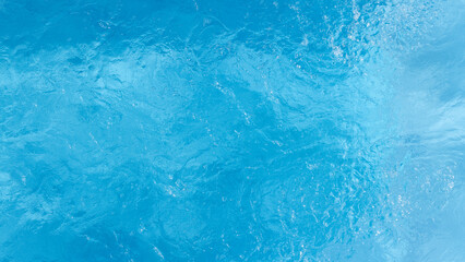 Top view blue water with ripple texture surface background, Blue water waves with shining pattern texture background, Abstract​​ surface​ blue​ water and ripple.