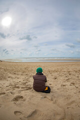 Woman by the sea in winter.