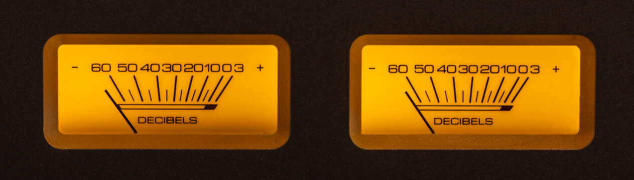 Audio Dual Volume Unit Meters Glowing in the Dark with Yellow and Orange Hues.