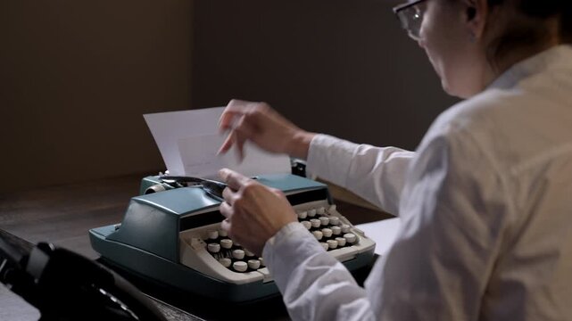 Person working on a vintage typewriter with paper inserted, struggling with sticking keys while typing. nostalgic retro office atmo. Answering a call on a retro telephone. 