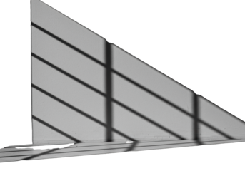 High-contrast monochromatic close-up of sharp, directional sunlight casting soft, blurred, geometric shadows onto a polished gray concrete wall, study in minimalist architecture and chiaroscuro