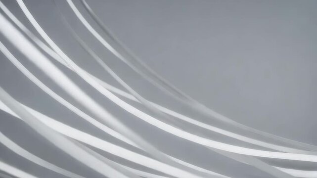 Abstract image of flowing white ribbons on a gray background.