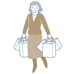 多数のショッピングバッグを持って歩くシニア女性