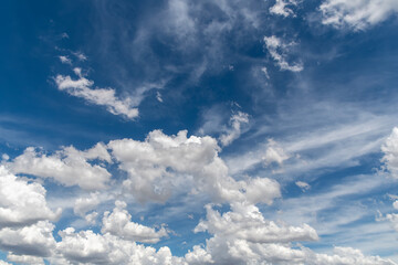 Cumulus and cirrus clouds in the blue sky