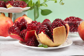 Fresh Ripe Pomegranates with Seeds on White Plates