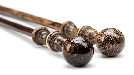 Close up of decorative brown and gold curtain rod finials on white background