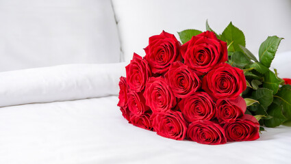 A beautiful bouquet of fresh red roses resting on a clean white surface.