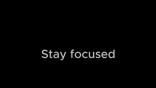 The simple motivational phrase 'Stay focused' in white. - Powered by Adobe