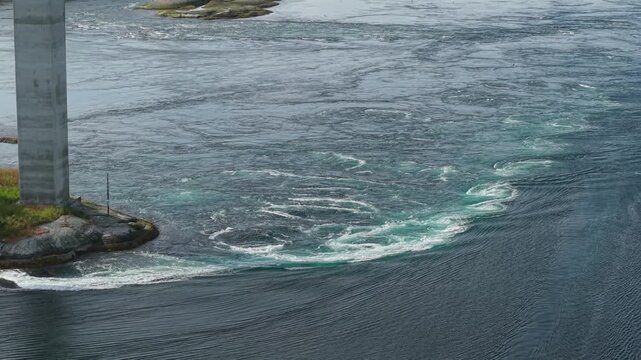 Fast-moving Tidal Water Forms Swirling Eddies and Powerful Currents at Saltstraumen, Norway - Aerial Pullback Shot