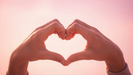 Fototapeta premium Happy Valentines couple making heart shape with hands against soft pink background