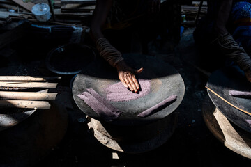 Women prepare 'Pitha', Assamese traditional rice-based sweets or snacks, on the 'Magh Bihu' festival