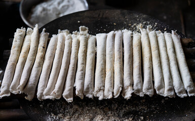 Vendor display Assamese traditional pitha, rice based snacks food items during Magh Bihu.