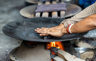 Women prepare 'Pitha', Assamese traditional rice-based sweets or snacks,  on the 'Magh Bihu' festival
