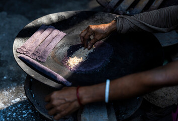 Women prepare 'Pitha', Assamese traditional rice-based sweets or snacks,  on the 'Magh Bihu' festival