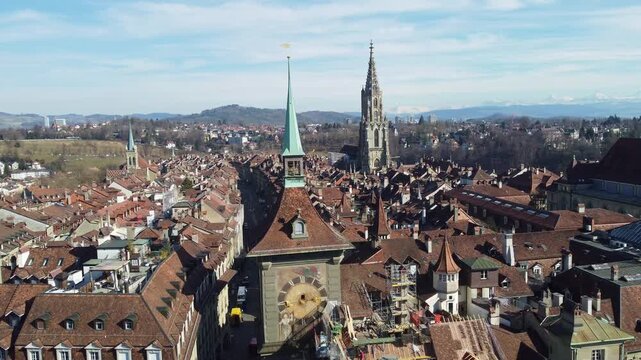 Bern, Switzerland: Aerial drone footage of Bern old town with the famous Zytglogge and cathedral bell tower in Switzerland capital city on a sunny winter day. 