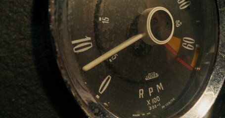 Close-up of the tachometer on the dashboard in a retro car