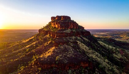 Sunset over rugged desert mountain landscape.