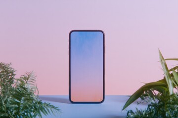 Minimalist smartphone surrounded by lush greenery against soft p