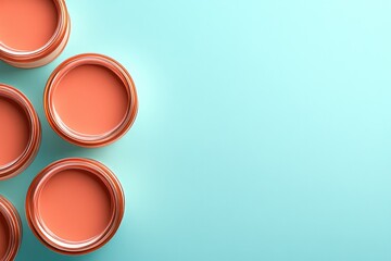 Bright paint cans arranged on soft turquoise background showcase