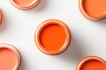 Bright orange paint cans arranged neatly, showcasing vibrant hue