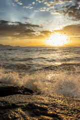 Ocean Waves Crashing on Rocks at Golden Hour Sunset