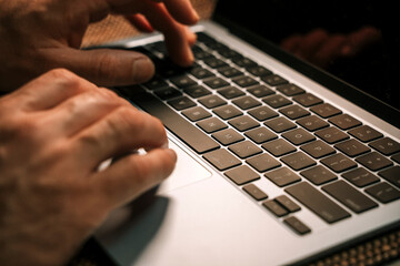 Working on a neon computer keyboard with colored backlighting. Computer video games, hacking, technology, internet concept. Selected focus. 