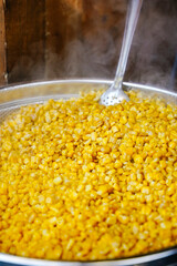 Hot Boiled Corn on the Cob in Large Pot at Street Food Market