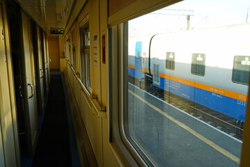 Passage in a passenger train carriage with a compartment.