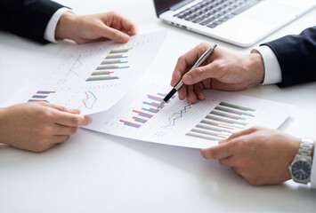 Business people analysing data charts for financial strategy