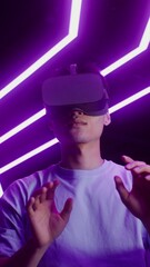 Man in virtual reality headset playing online video game in VR studio