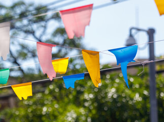 A bunch of colorful flags hanging from a wire