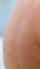 A person's back with water droplets on it