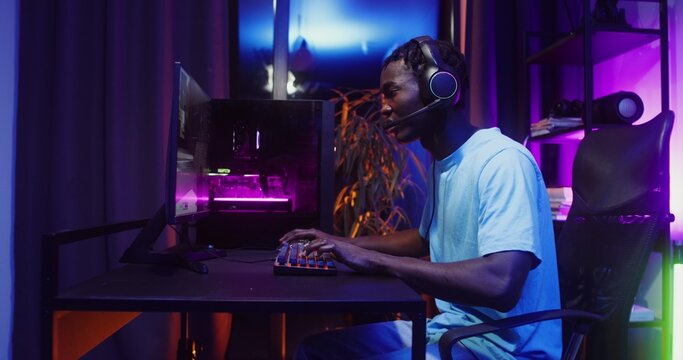 Man playing computer video games at home
