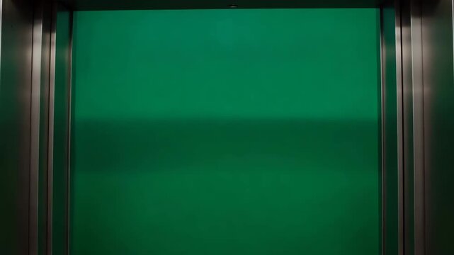 Modern Elevator Doors Opening with Vibrant Green Screen