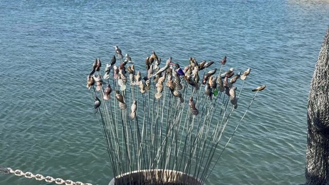 African curio trinkets against a backdrop of blue water at a harbour inCape Town