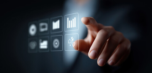Finger presses dashboard icon on virtual interface in dark modern setting.​