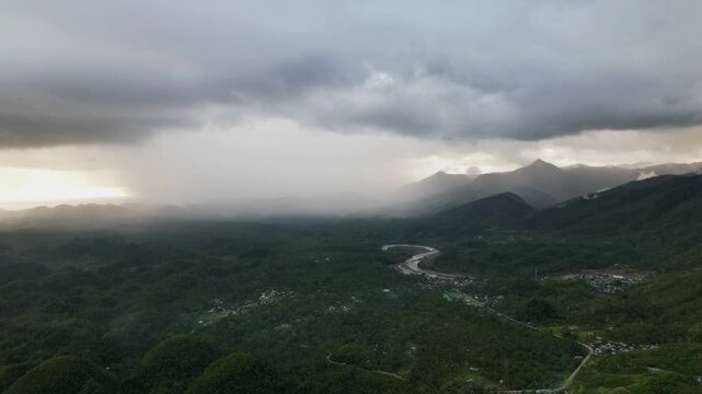 Stunning aerial timelapse of thick, dark rain clouds passing over lush, tropical island province - Catanduanes, Bicol, Philippines